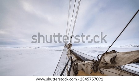 a ship, bowsprit, pack ice and cloud scape; Spar and furled sail; Spitzbergen,  Poolepynten, Spitzbergen