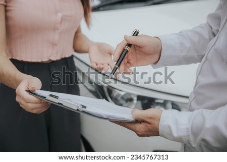 Insurance Agent examine Damaged Car and filing Report Claim Form after accident, Traffic Accident and insurance concept.