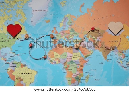 Decorative cord with hearts on world map symbolizing connection in long-distance relationship, top view Royalty-Free Stock Photo #2345768303