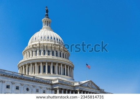 The United States Capitol building with American flag, Washington DC, USA. Royalty-Free Stock Photo #2345814731