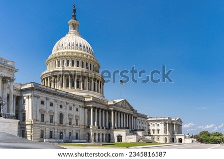 The United States Capitol building with American flag, Washington DC, USA. Royalty-Free Stock Photo #2345816587