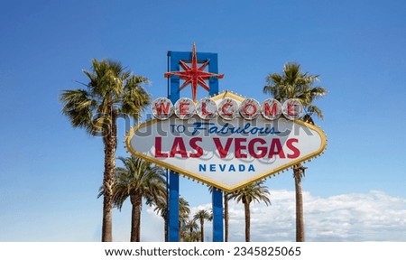 Welcome to Fabulous Las Vegas Nevada Sign. Palm tree behind neon billboard, invitation for entertainment at USA casino, blue sky background.
