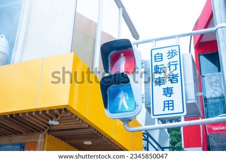 Japanese traffic signal that changes color when pedestrians press a button. Translation,japanese traffic lights, Traffic signals in Japan in town push button.