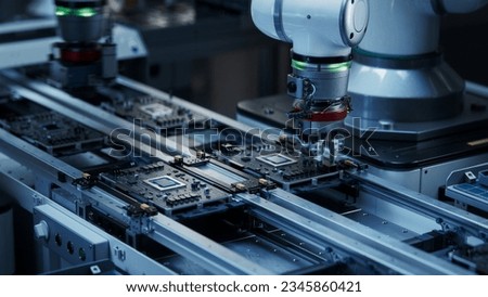 Component Installation and Quality Control of Black Circuit Board. Fully Automated PCB Assembly Line Equipped with High Precision Robot Arms at a Factory. Electronic Devices Manufacturing Industry