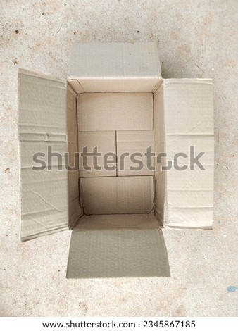 Brown cardboard boxes on cement floor
