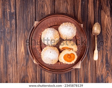 Austrian and czech sweet dessert knedle apricot dumplings on wooden background. Filled cottage cheese dough. top view