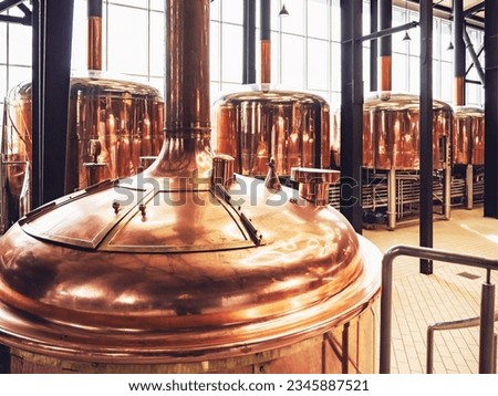 Micro Brewery and equipment. Round copper storage tanks for beer fermentation and maturation. Brew manufacturing Royalty-Free Stock Photo #2345887521