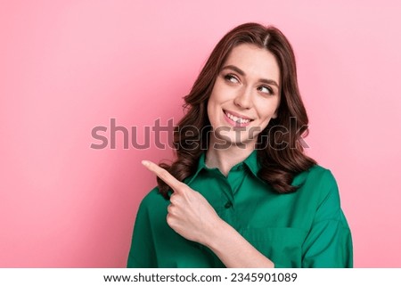 Photo of dreamy sweet lady wear green shirt pointing finger looking empty space isolated pink color background
