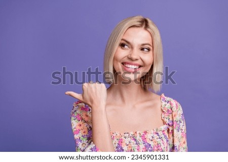 Portrait of nice positive girl beaming smile look direct thumb finger empty space isolated on purple color background