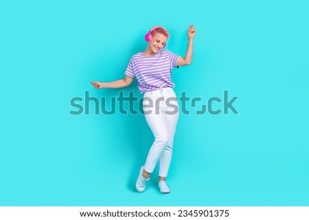 Full body size photo of chilling dancer girl young wear striped t shirt enjoy cool music earphones isolated on aquamarine color background