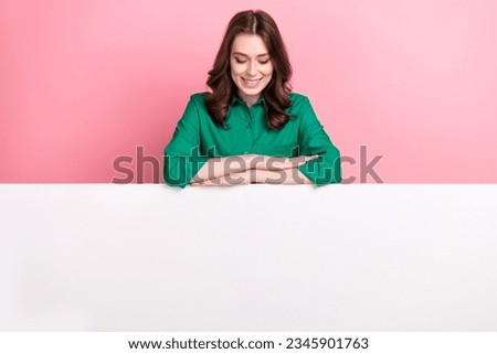 Photo of funky cheerful lady wear green shirt looking placard empty space isolated pink color background