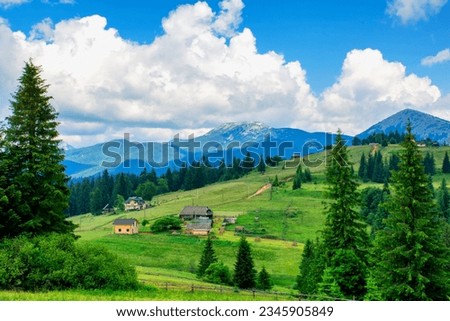 Beautiful scenery of a village in a valley against the backdrop of blue mountains, travel, vacation. High quality photo