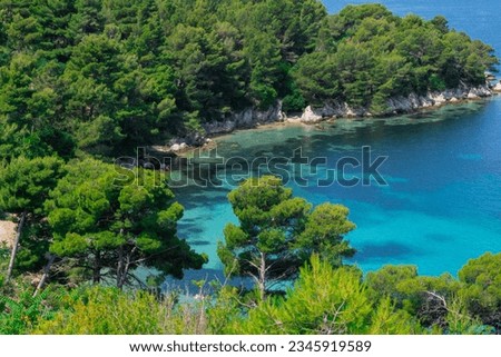 Amazing landscape overlooking a beautiful lagoon, pine forest and wild beach. Wonderful turquoise water of the Adriatic Sea, Mountains are visible on the background.