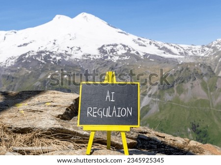 AI regulation symbol. Concept words AI artificial intelligence regulation on blackboard. Beautiful mountain Elbrus background. Business AI artificial intelligence regulation concept. Copy space