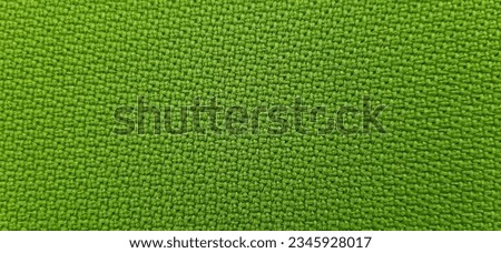 Green fabric background and woven material are perfect for the sofa. Closed up, selective and high resolution.