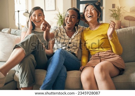 Happy, friends and women watching tv on a sofa laughing, bond and relax in their home on the weekend. Television, movie and people with diversity in living room for streaming, film or comedy in house