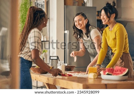 Friends, smile and women cooking pizza in kitchen, bonding and having fun together in home. Happy, girls and baking food, margherita and salami bread at lunch, cheese on meat and brunch in house Royalty-Free Stock Photo #2345928099