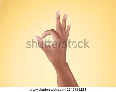 Great, ok and hand sign in studio with decision, agreement and success of good news. Yellow background, yes vote and accept approval of a person showing agree, opinion and emoji icon and signal