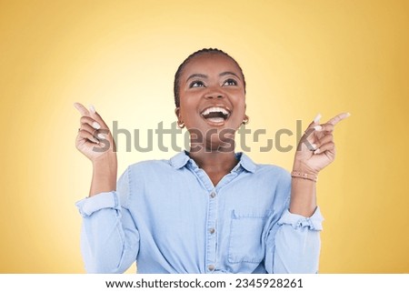 Pointing up, choice or excited black woman in studio for mockup space, sale news or deal offer. Yellow background, advertising or happy person thinking of promotion ideas, announcement or retail deal Royalty-Free Stock Photo #2345928261