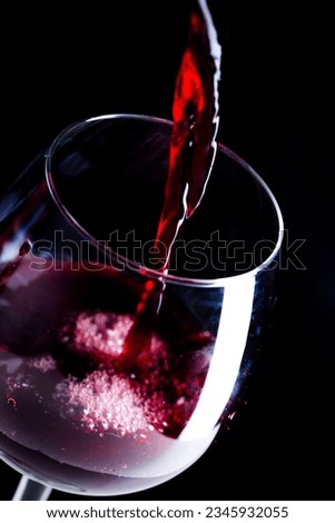 Pouring red wine into the glass Royalty-Free Stock Photo #2345932055