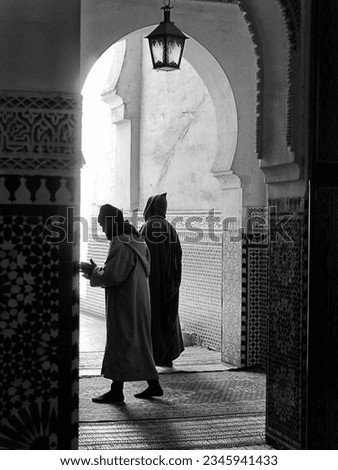 Two men in archway, Imperial Palace of Moulay Ismail, Meknes, Morocco. Black and white. High quality photo