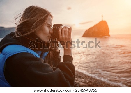 Woman travel sea. Happy tourist enjoy taking picture outdoors for memories. Woman traveler looks at sea bay of mountains, sharing travel adventure journey