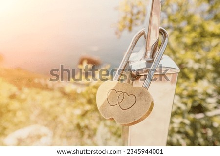 Wedding Heart Golden Lock on stainless iron fence. Valentine's day. Symbol of eternal love. A wedding tradition all over the world to hinder the lock. Monument on the wedding day.