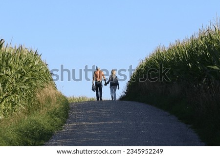  elderly coouple walking on trail in countryside