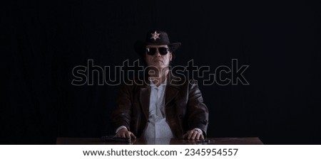 portrait of the sheriff in the office at the table Royalty-Free Stock Photo #2345954557
