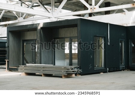A new wooden modular prefabricated house inside an industrial building Royalty-Free Stock Photo #2345968591