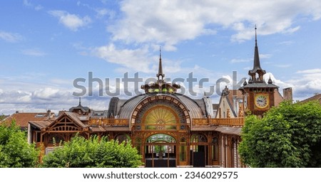 Refreshment room Cachat and its clocktower being restored, near the historical mineral water source in Evian-les-Bains, Haute Savoie, France Royalty-Free Stock Photo #2346029575