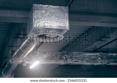 Air ventilation system on the ceiling in a large warehouse Royalty-Free Stock Photo #2346035331