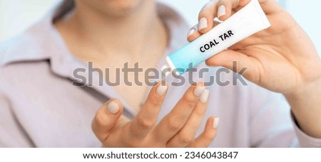Coal Tar: A cream containing coal tar extract used to treat psoriasis, eczema, and other inflammatory skin conditions. Royalty-Free Stock Photo #2346043847