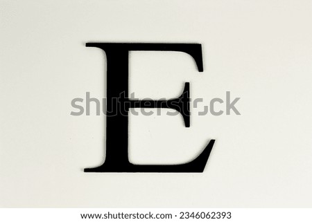 Capital letters in black on white background - black lettering