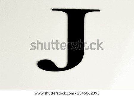 Capital letters in black on white background - black lettering
