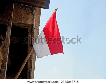 The Indonesian Red and White national flag flies on a bamboo pole. Commemoration of Indonesian Independence Day on August 17
