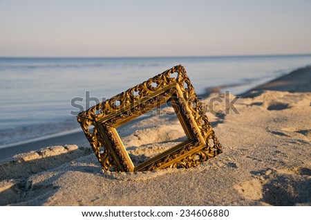 vintage golden picture frame on sea resort beach in sunrise light