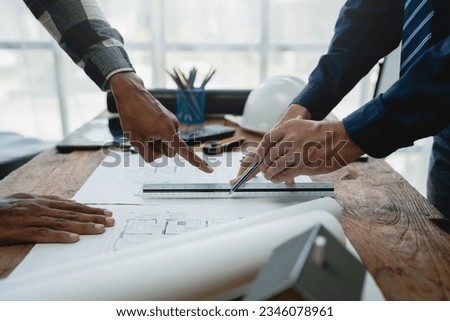 Team of engineers reviewing blueprints Sketch of a new construction project with engineering tools at office desk. For improvement of house designs in mortgage, rent, sale, real estate