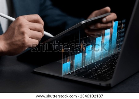 stock trading ideas Businessman holding smartphone with stock chart showing various analytical data to make a purchase decision stock trading, wealth stock investing digital transformation technology Royalty-Free Stock Photo #2346102187