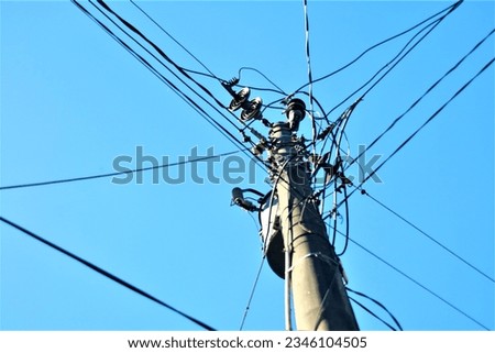 electric pole in minimalistic composition over clear blue sky