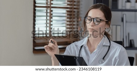female doctor with laptop consulting patient online by computer video call conversation in her hospital office, Healthcare and medical concept.