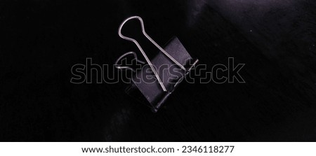 1 old black paper clip

