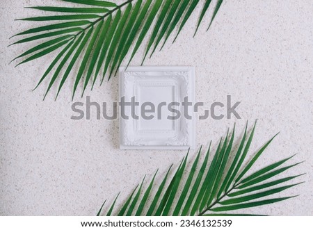 Summer white picture frame mockup template on a sand background with palm tree and sand. Tropical vacation or holidays concept. Summer memories.