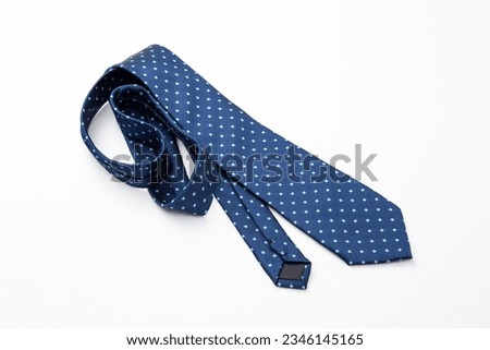 A tie with a polka dot pattern on a white background. Royalty-Free Stock Photo #2346145165
