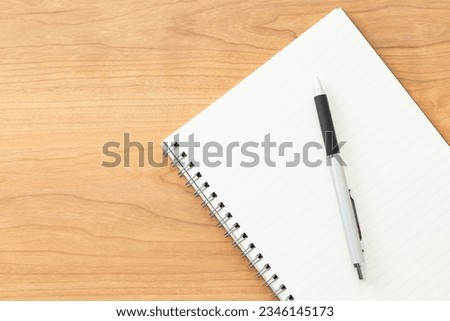 A notebook and pen on the desk.