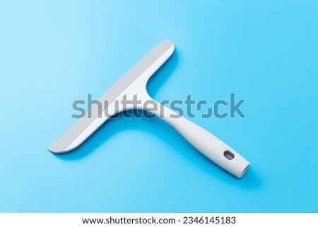 A new squeegee on a blue background.