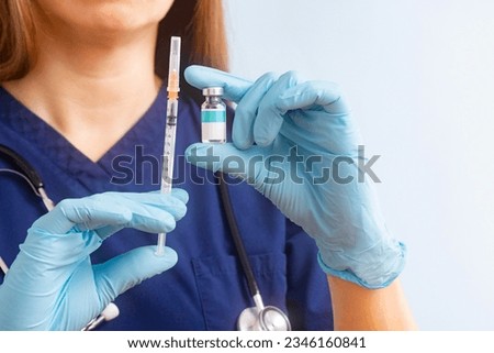 Vial vaccine and disposable syringe for injection in doctor hands Royalty-Free Stock Photo #2346160841