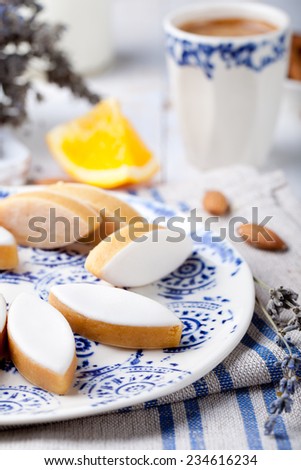 Calissons d'Aix-en-Provence on a ceramic plate on a white wooden background. Traditional French Provence sweets.