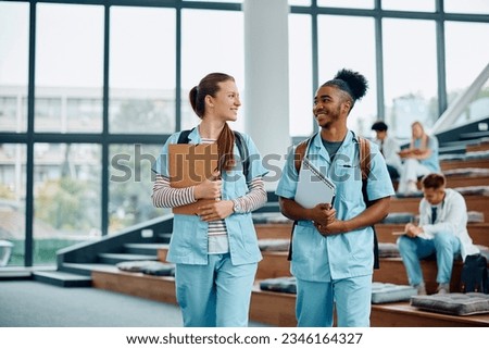 Happy multiracial nursing students talking at medical university. Copy space. 