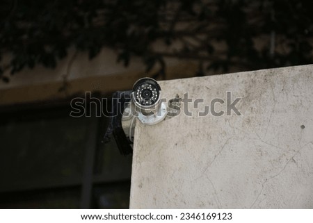 outdoor surveillance camera hanging on the wall